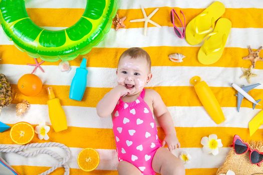 A child girl smears sunscreen on her skin. Selective focus. Kid.