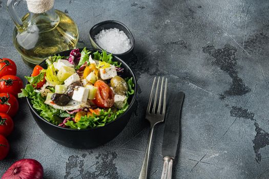 Greek salad with feta cheese and organic fresh olives, on gray background with copy space for text