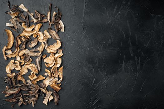 Dried porcini mushrooms set, on black background, top view flat lay , with space for text copyspace