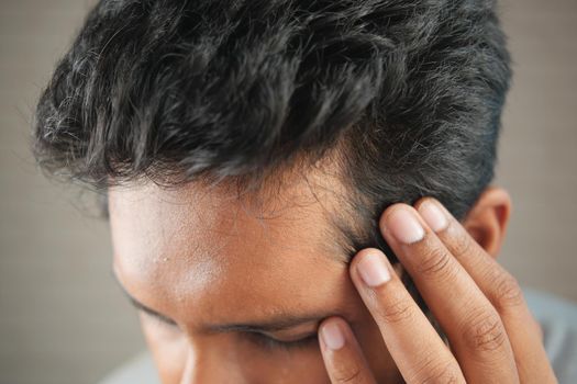 hair loss concept with man checking his hair .