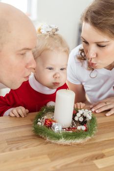 Baby child with hearing aid and cochlear implant having fun with parents in christmas room. Deaf and health