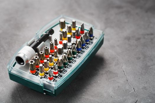 A set of metal bits for screwdrivers in a box. Hexagon head of different sizes