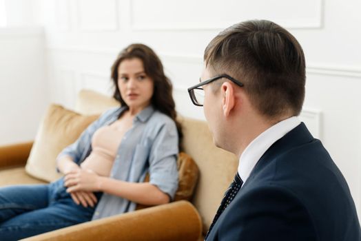 A young woman talks about her problems to a man psychologist. The concept of mental disorders. Selective focus.