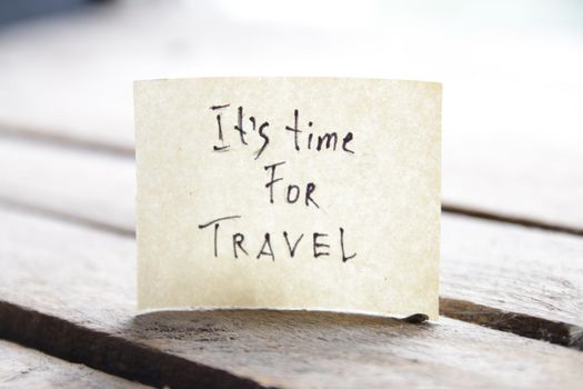 It's travel time. Paper card with an inscription. Summer Vacations idea. High quality photo