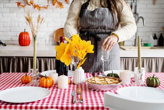 Happy Thanksgiving Day. Autumn feast. Woman celebrating holiday cooking traditional dinner at kitchen, decorating home