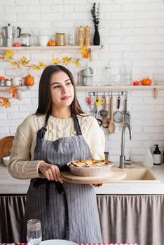 Happy Thanksgiving Day. Autumn feast. Woman celebrating holiday cooking traditional dinner at kitchen