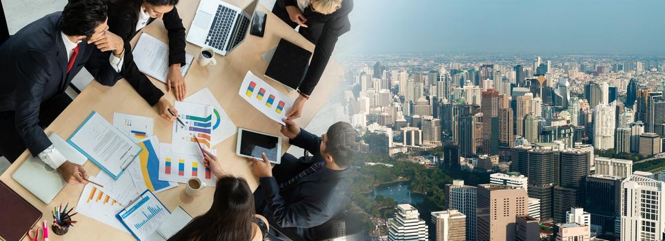 Business people group meeting shot from top widen view in office . Profession businesswomen, businessmen and office workers working in team conference with project planning document on meeting table .