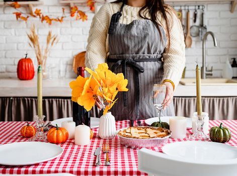 Happy Thanksgiving Day. Autumn feast. Woman celebrating holiday cooking traditional dinner at kitchen, decorating home