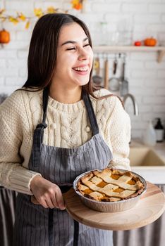 Happy Thanksgiving Day. Autumn feast. Woman celebrating holiday cooking traditional dinner at kitchen