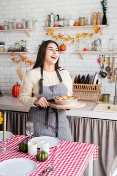 Happy Thanksgiving Day. Autumn feast. Woman celebrating holiday cooking traditional dinner at kitchen