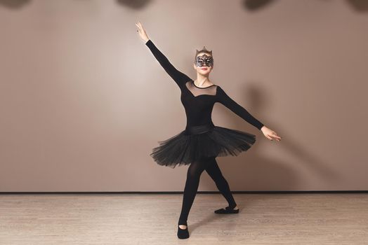 Beautiful graceful ballerina in black swan dress. Young ballet dancer practicing before performance in black tutu, classical dance studio, copy space