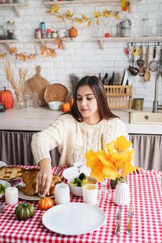 Happy Thanksgiving Day. Autumn feast. Woman celebrating holiday cooking traditional dinner at kitchen