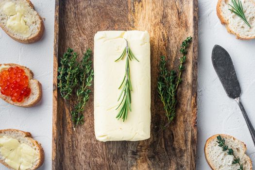 A piece of fresh butter, on white background, top view flat lay