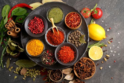 Various spices a vintage spoons on stone table. Colorful Herbal and Spices Oriental marketplace.