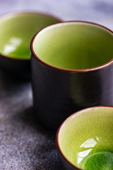 Round geometric green ceramic shapes on concrete background