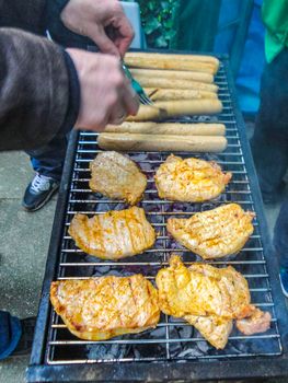 Preparing Barbeque BBQ Campfire and sausages meat steak chicken in Leherheide Bremerhaven Bremen Germany.