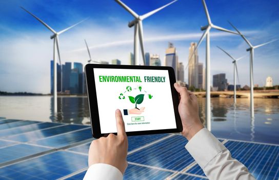 Green business transformation for environment saving and ESG business concept. Businessman using tablet to set corporate goal toward environmental friendly management and alternative clean energy use.