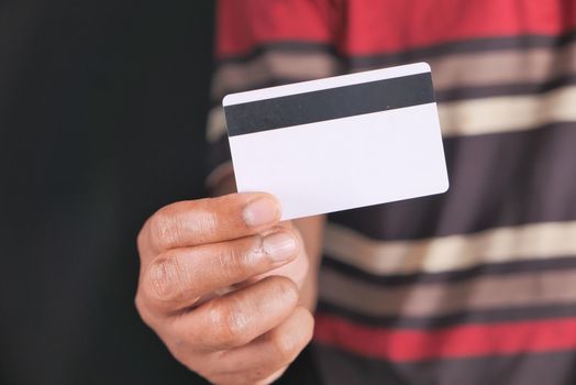 hand holding credit cards reading information .