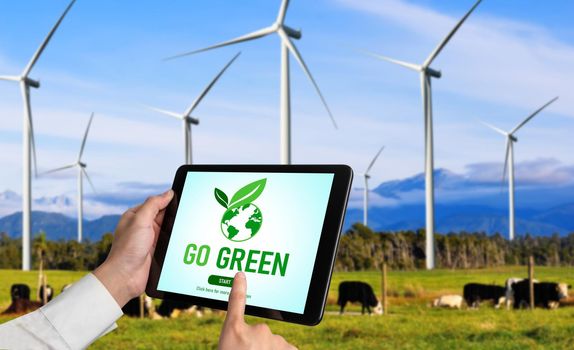 Green business transformation for environment saving and ESG business concept. Businessman using tablet to set corporate goal toward environmental friendly management and alternative clean energy use.