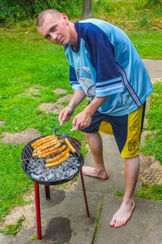 Preparing Barbeque BBQ Campfire and sausages meat steak chicken in Speckenbütteler Park Lehe Bremerhaven Bremen Germany.