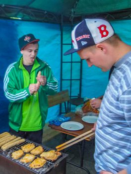 Preparing Barbeque BBQ Campfire and sausages meat steak chicken in Speckenbütteler Park Lehe Bremerhaven Bremen Germany.