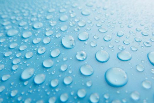 Rain drops on blue background , rainy day.