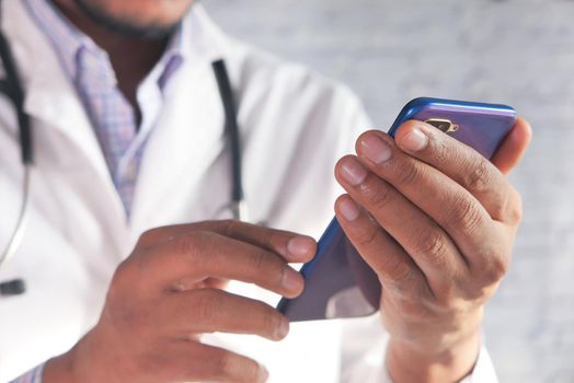 selective focus .close up of doctor using smart phone .