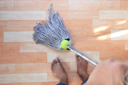 Home, housekeeping concept cleaning wooden floor with mop