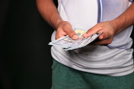 Close up of man hand counting 100 us dollar cash .