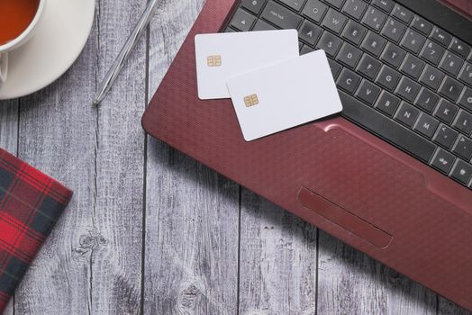 high angle view of credit cards on laptop on white background .