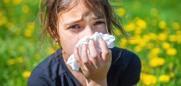 The child is allergic to flowers. Selective focus. nature.