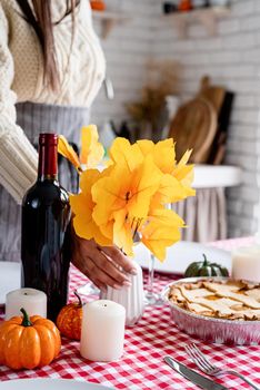 Happy Thanksgiving Day. Autumn feast. Woman celebrating holiday cooking traditional dinner at kitchen, decorating home