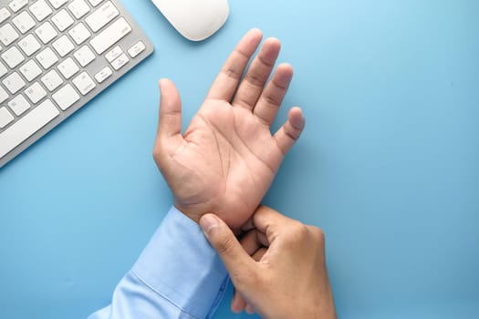 Young man in suffering wrist pain, close up.
