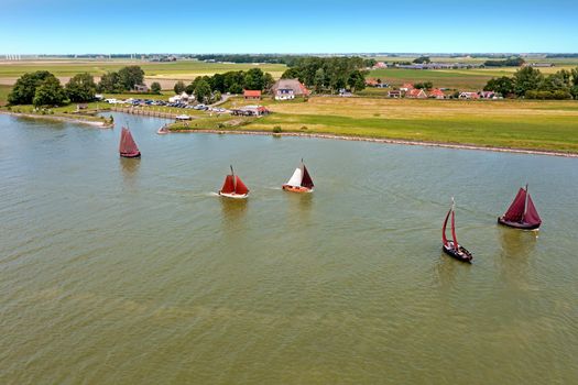 Aerial from traditional dutch wooden boats at the IJsselmeer near the harbor from Laaxum in Friesland the Netherlands