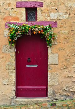 Handmade wreath on a red vintage door Thanksgiving Day Christmas