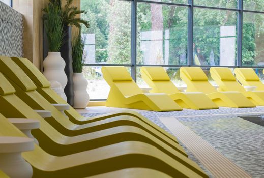 Row of yellow chaise longue for relax