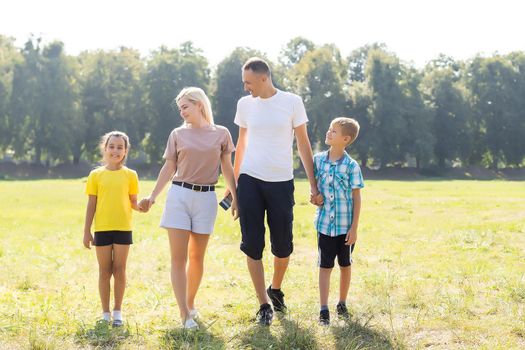 Happy family enjoying life together at meadow outdoor