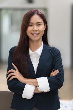 A portrait of Asian happy Businesswoman smiling and working at office