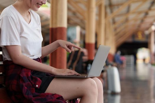 Pretty Young traveler woman excite and planning trip at train station. Summer and travel lifestyle concept