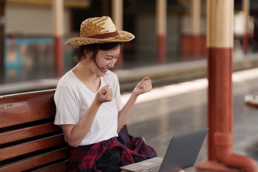 Pretty Young traveler woman excite and planning trip at train station. Summer and travel lifestyle concept