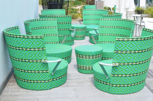 Comfortable green wicker chairs and table in a restaurant