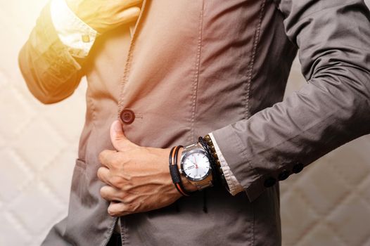 closeup the man's wrist wearing bracelets and wristwatch, casual style of men accessories.