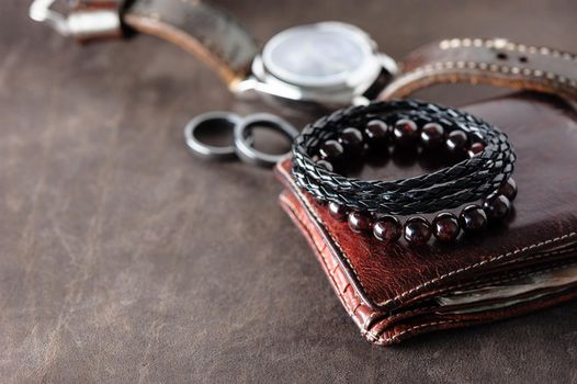 closeup black braided leather bracelet for men, casual style of men accessories. Shallow depth of field.