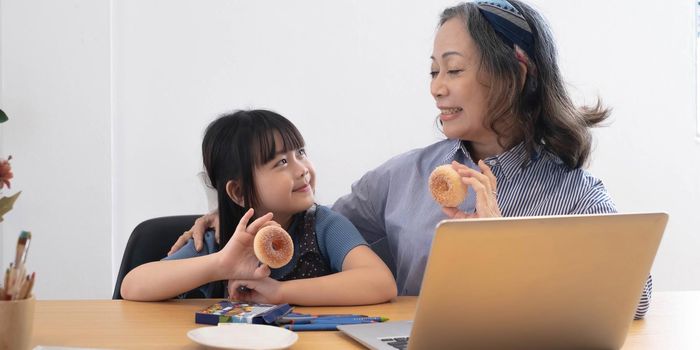 little girl eating snacks with grandma.