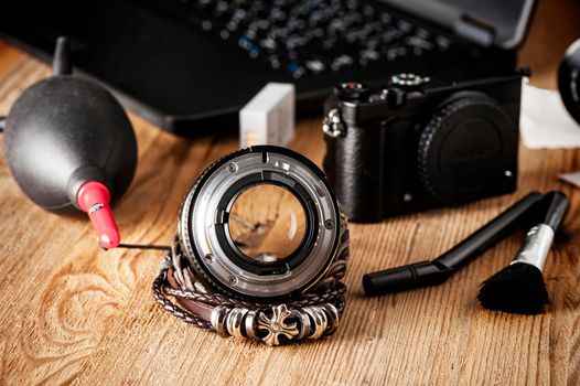 Camera and lens care. Camera cleaning kits and camera gears on photographer's desktop.