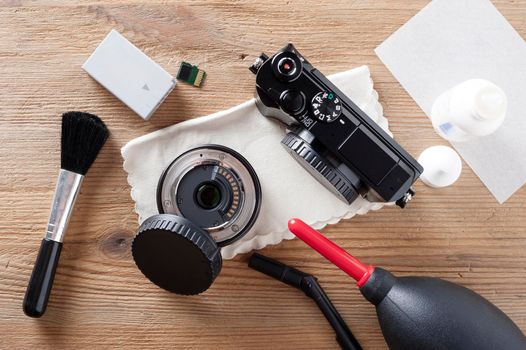 Camera and lens care. Camera cleaning kits and camera gears on photographer's desktop.