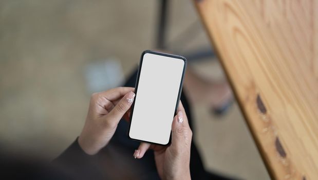 Woman using mobile phone, empty mockup screen for your own design.