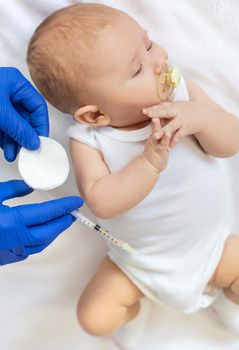 Vaccination baby, injection in the arm. Selective focus. People.
