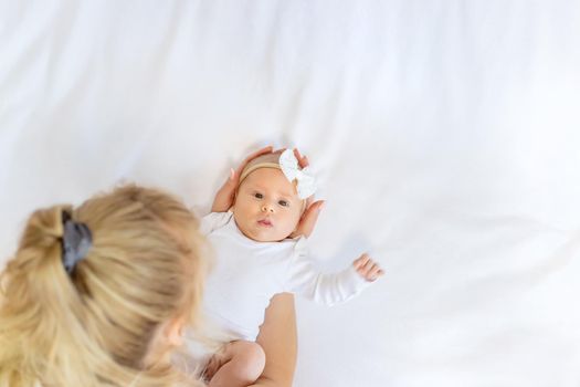 Mom is holding a newborn baby. Selective focus. People.