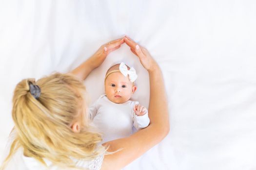 Mom is holding a newborn baby. Selective focus. People.